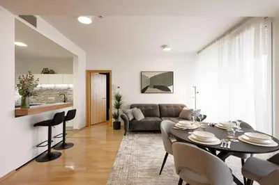 a living room with a table and a couch at Apartma Masada in Maribor