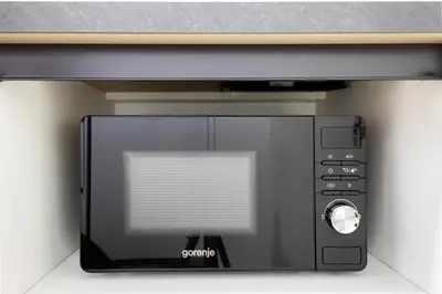 a microwave oven sitting on top of a wall at Apartma Masada in Maribor