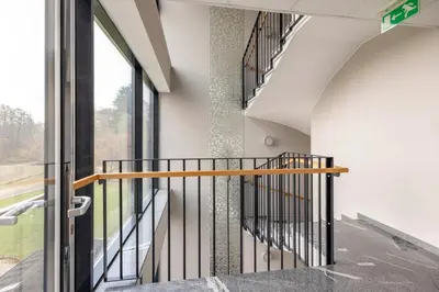 a staircase in a building with a window at Apartma Masada in Maribor