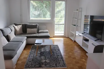 a living room with a couch and a tv at Apartment Valis in Velenje