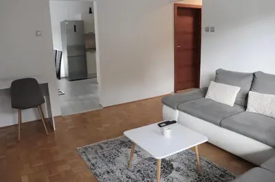 a living room with a couch and a table at Apartment Valis in Velenje