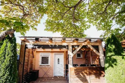 a tiny house with a porch and a white door at Holiday home Pandora in Brežice