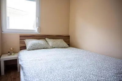 a bedroom with a white bed with a window at Holiday home Pandora in Brežice