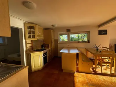 a kitchen with a table and a counter top at Ljubljana Garden Apartment - Free Parking in Ljubljana
