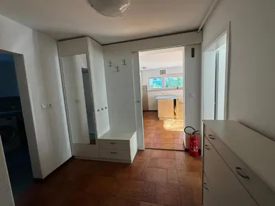 a kitchen with a white cabinet and a hallway at Ljubljana Garden Apartment - Free Parking in Ljubljana