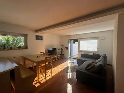 a living room with a couch and a table at Ljubljana Garden Apartment - Free Parking in Ljubljana