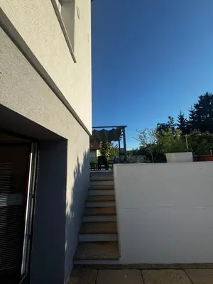 a stairway leading to a building with a blue light at Ljubljana Garden Apartment - Free Parking in Ljubljana
