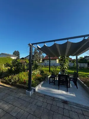a patio with a table and chairs under a canopy at Ljubljana Garden Apartment - Free Parking in Ljubljana