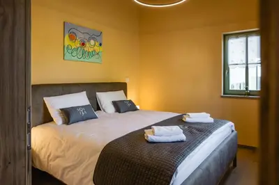 a bedroom with a bed with two towels on it at Villa Sofija in Kojsko