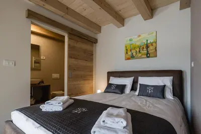 a bedroom with a bed with towels on it at Villa Sofija in Kojsko