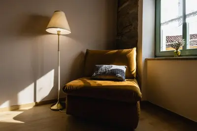 a lamp sitting next to a chair next to a window at Villa Sofija in Kojsko