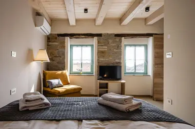 a bedroom with a bed with towels on it at Villa Sofija in Kojsko
