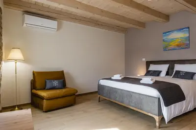 a bedroom with a bed and a chair at Villa Sofija in Kojsko