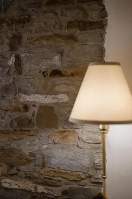 a lamp in front of a stone wall at Villa Sofija in Kojsko