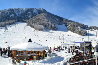 a group of people on a snow covered ski slope at Apartments Demec in Kranjska Gora