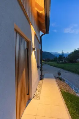 a walkway leading to the side of a building at Cherryhood Chalet in Bohinj