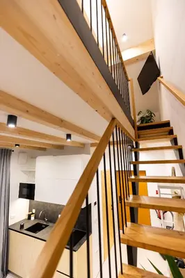 a wooden staircase in a house with a sink at Cherryhood Chalet in Bohinj