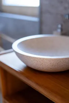 a white sink sitting on a wooden table at Cherryhood Chalet in Bohinj
