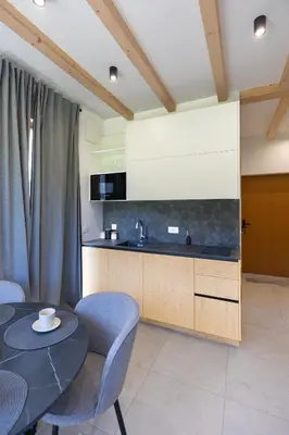 a kitchen with a table and a counter top at Cherryhood Chalet in Bohinj