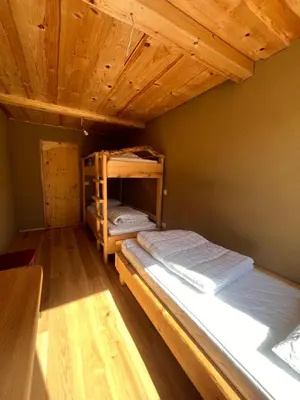 two bunk beds in a room with a wooden ceiling at Ethno holistic village Apače in Apače