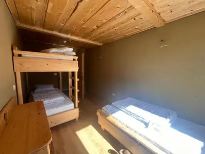 two bunk beds in a room with a wooden ceiling at Ethno holistic village Apače in Apače