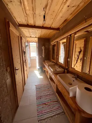 a bathroom with a row of sinks and mirrors at Ethno holistic village Apače in Apače
