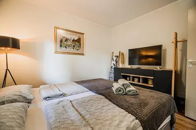 a bedroom with a bed and a flat screen tv at Apartment Luna 65 in Podčetrtek