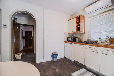 a kitchen with white cabinets and a counter top at Apartment Luna 65 in Podčetrtek