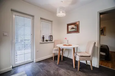 a dining room with a table and chairs and a window at Apartment Luna 65 in Podčetrtek