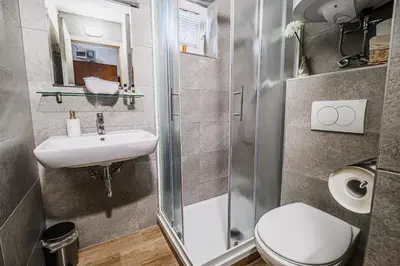 a small bathroom with a toilet and a sink at Apartment Luna 65 in Podčetrtek