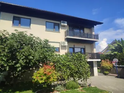 a building with a balcony and some bushes at Altitude50 apartment Domžale in Domžale