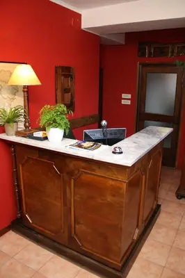 a kitchen with a island in a room with red walls at The Blue House in Tolmin