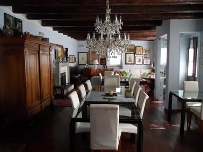a dining room with a table and white chairs at The Blue House in Tolmin