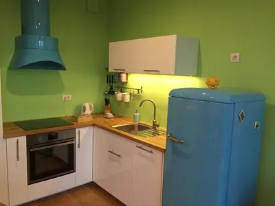 a kitchen with a blue refrigerator and a sink at TiliaStay in Ljubljana