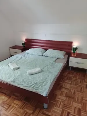 a bedroom with a bed with two towels on it at Emma's Holiday Home in Brežice