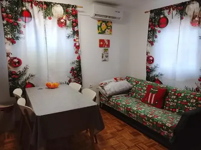 a living room with a table and a couch at Emma's Holiday Home in Brežice