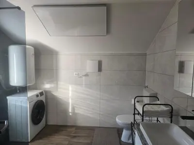 a bathroom with a washing machine and a sink at Apartmaji Beli Jelen