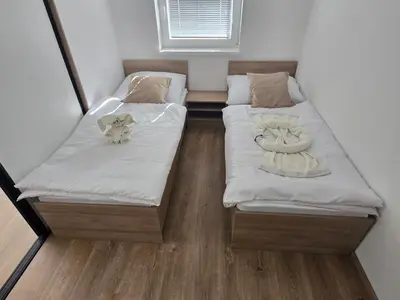 two beds in a small room with aermottermott at Apartmaji Beli Jelen