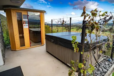 a view from the back of a house with a hot tub at Hill Stars House in Straža