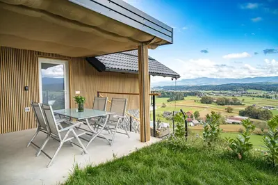 a table and chairs on a patio with a view at Hill Stars House in Straža