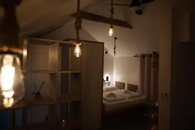 a room with a bedroom with a bed and lights at Hill Stars House in Straža