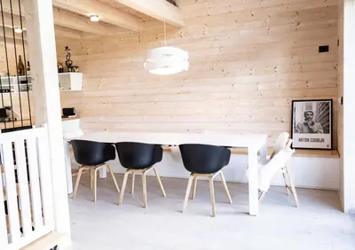 a dining room with a white table and chairs at Chalet Aurora