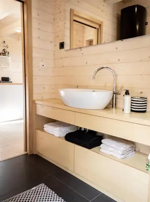 a bathroom with a sink on a wooden wall at Chalet Aurora