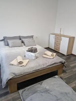 a bedroom with a bed with towels and a dresser at Vila Marina in Prestranek