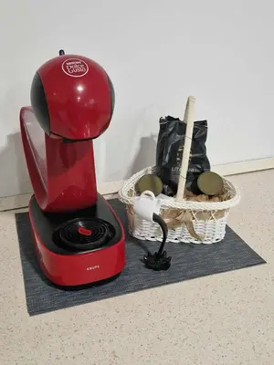 a red blender sitting on a counter next to a basket at Vila Marina in Prestranek
