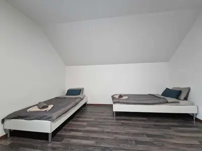 two beds sitting next to each other in a room at Vila Marina in Prestranek