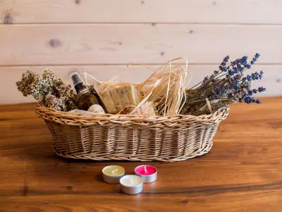 a basket of wine and flowers on a table at Serene Rustic Haven Holiday Home with Sauna - Two Bedroom Holiday Home with Sauna in Bistrica ob Sotli
