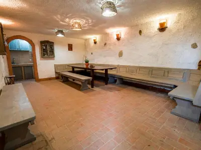 a room with benches and a table in a building at Serene Rustic Haven Holiday Home with Sauna - Two Bedroom Holiday Home with Sauna in Bistrica ob Sotli