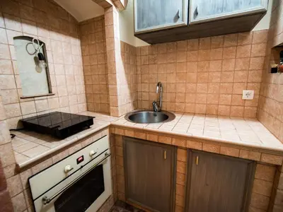 a small kitchen with a sink and a counter top at Serene Rustic Haven Holiday Home with Sauna - Two Bedroom Holiday Home with Sauna in Bistrica ob Sotli