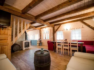 a large living room with a table and a fireplace at Serene Rustic Haven Holiday Home with Sauna - Two Bedroom Holiday Home with Sauna in Bistrica ob Sotli